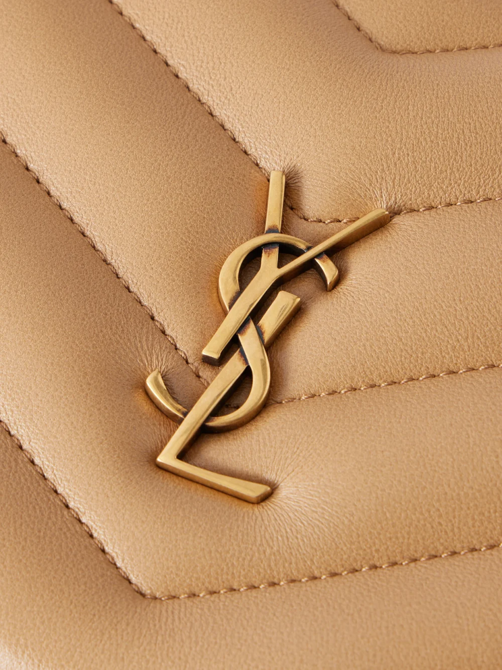 Close-up detail of the Saint Laurent Loulou Cassandre-embellished Matelassé Textured-leather Shoulder Bag