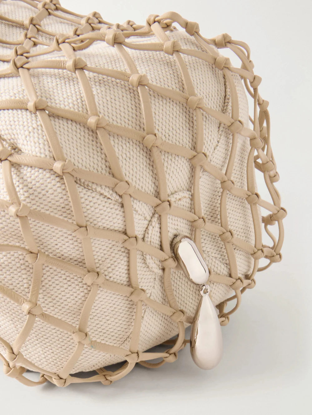 Close-up detail of the Savette Macrame Bead-embellished Canvas-trimmed Leather Clutch
