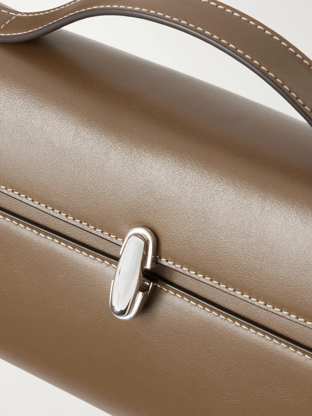 Close-up detail of the Savette Symmetry Trapeze Pochette Leather Top-handle Bag