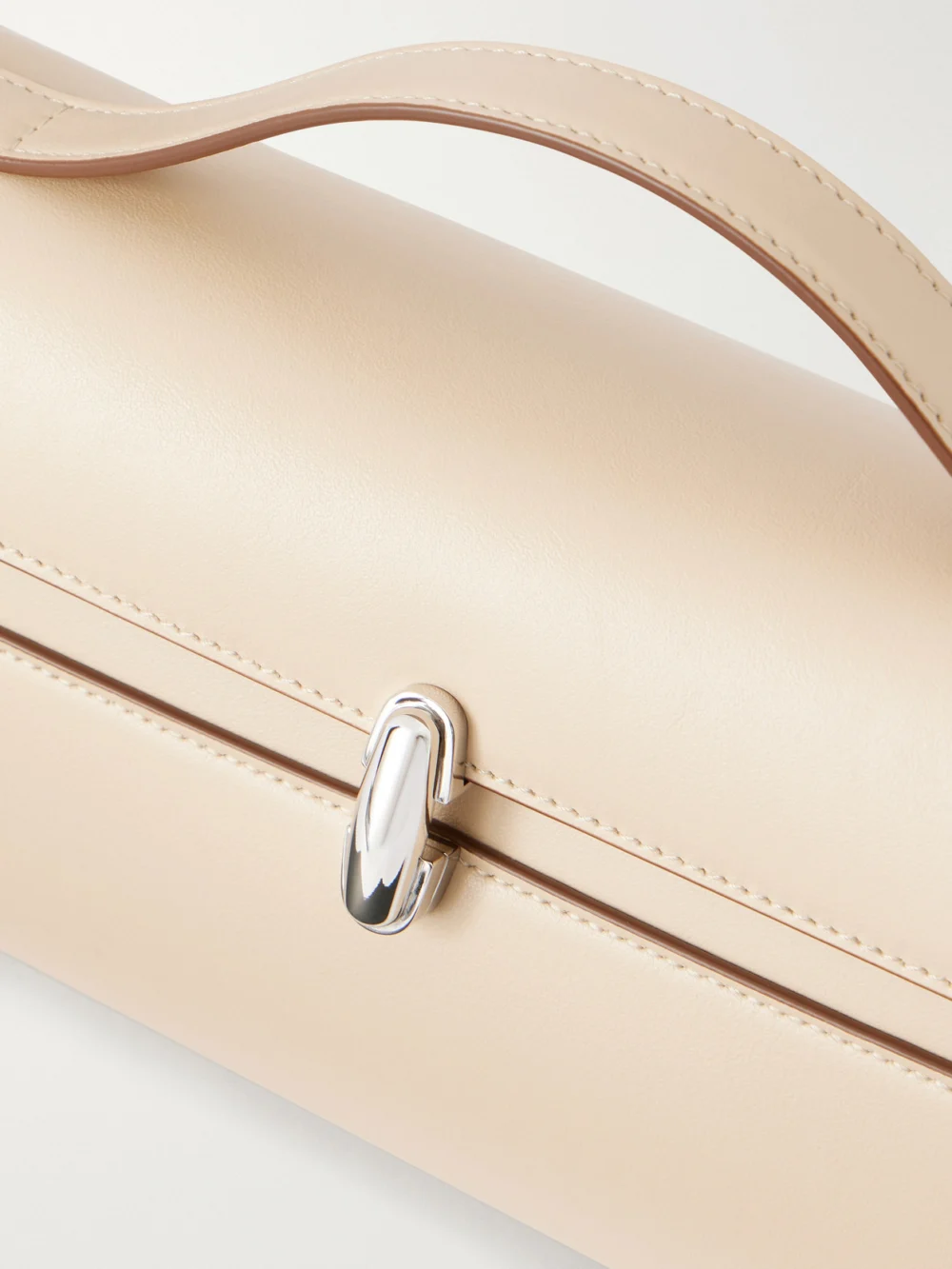 Close-up detail of the Savette Symmetry Trapeze Pochette Leather Top-handle Bag