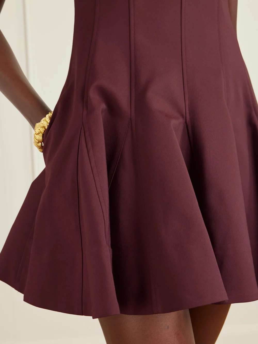 Close-up detail of the Simkhai Emslie Paneled Pleated Cotton-blend Mini Dress
