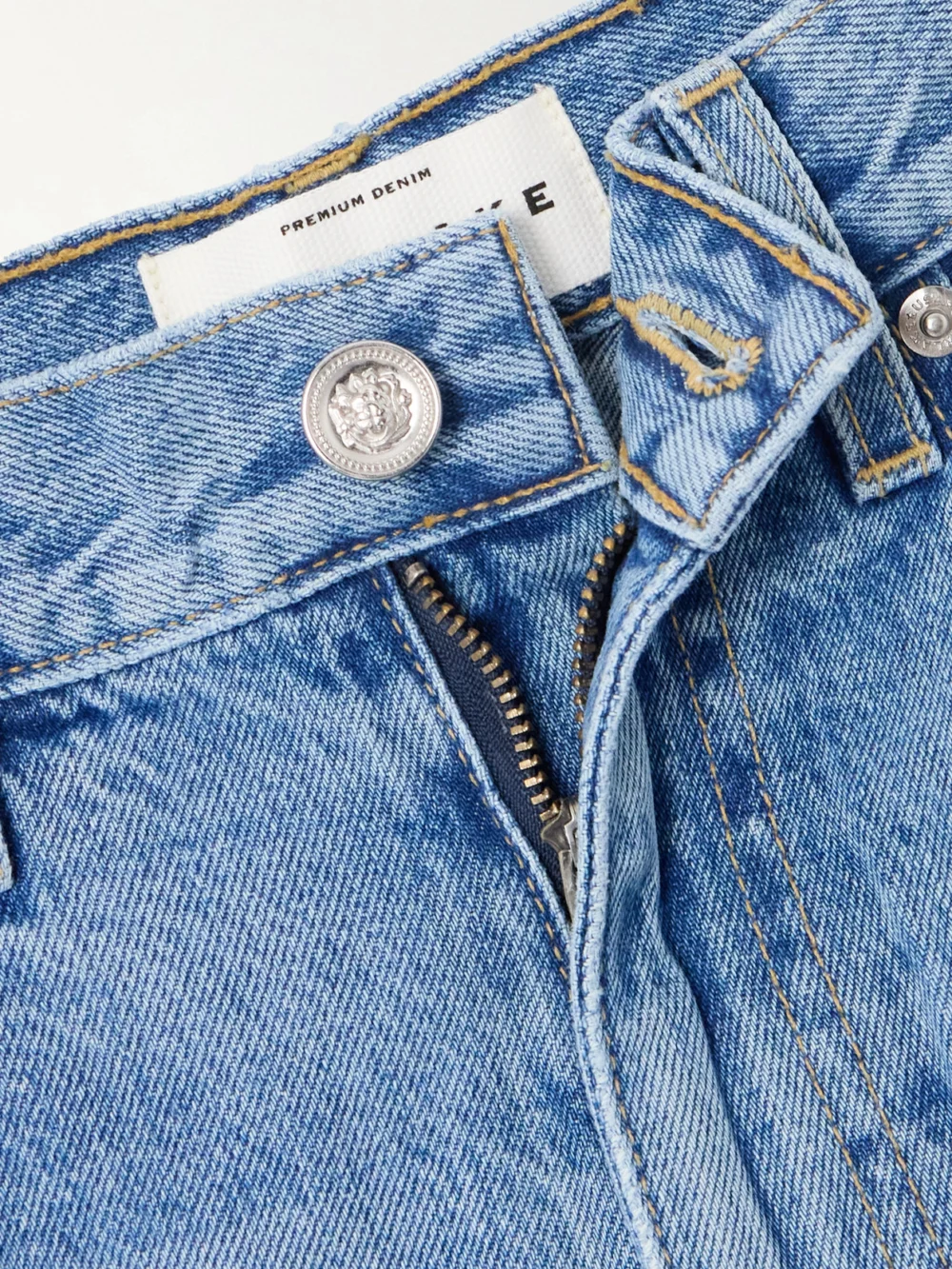 Close-up detail of the Slvrlake London Ankle Cropped Distressed High-rise Straight-leg Jeans