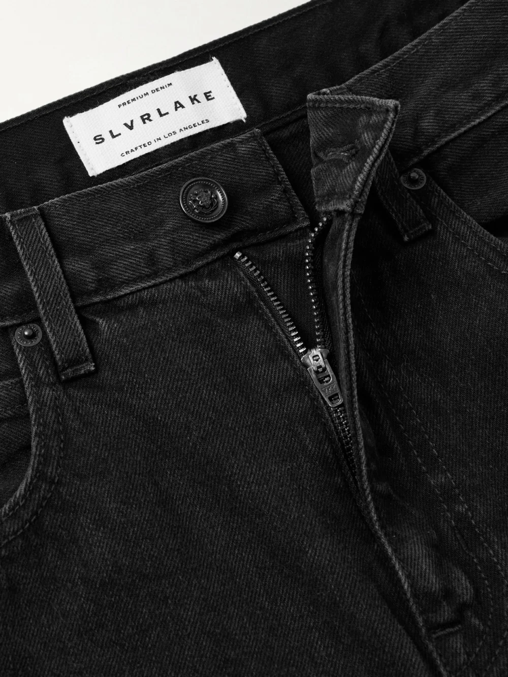 Close-up detail of the Slvrlake Re-worked Panelled London Frayed Paneled Organic High-rise Straight-leg Jeans