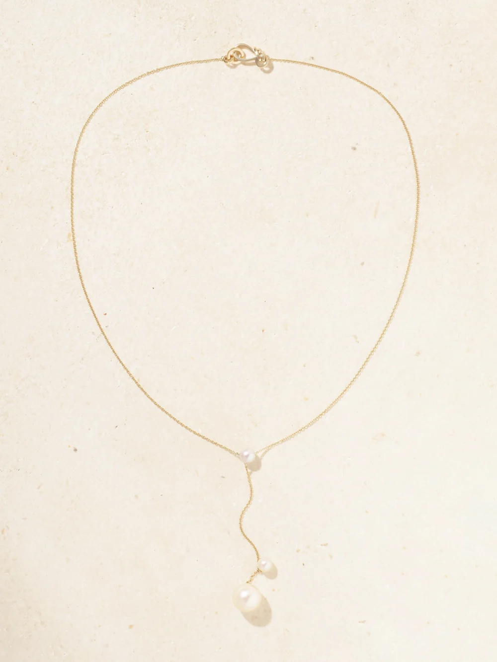 Close-up detail of the Sophie Bille Brahe Trois Moon 14-karat Recycled Gold Pearl Necklace