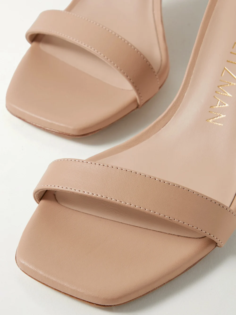 Close-up detail of the Stuart Weitzman Nudistcurve Leather Sandals