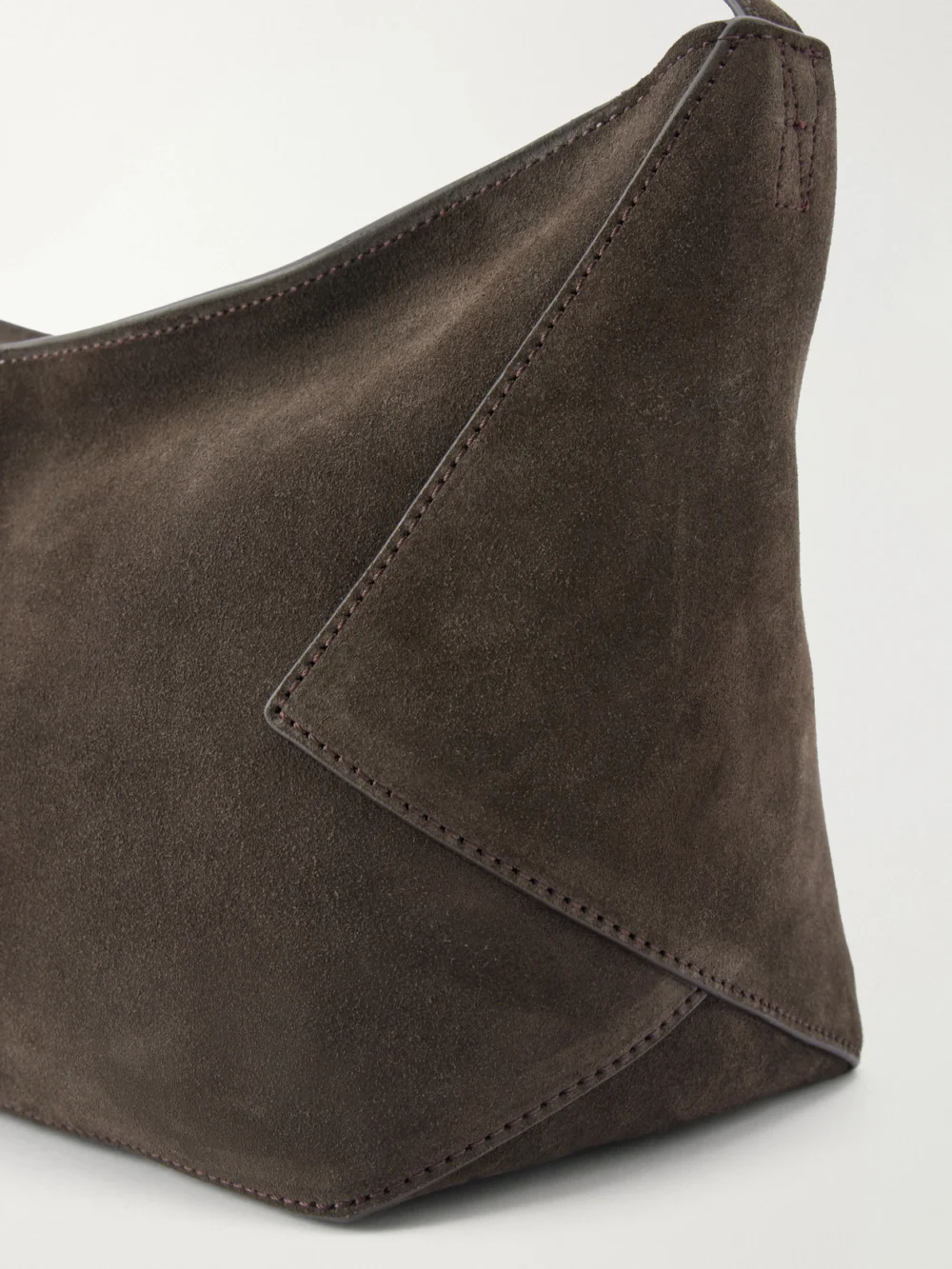 Close-up detail of the Studio Nicholson Hagu Suede Shoulder Bag