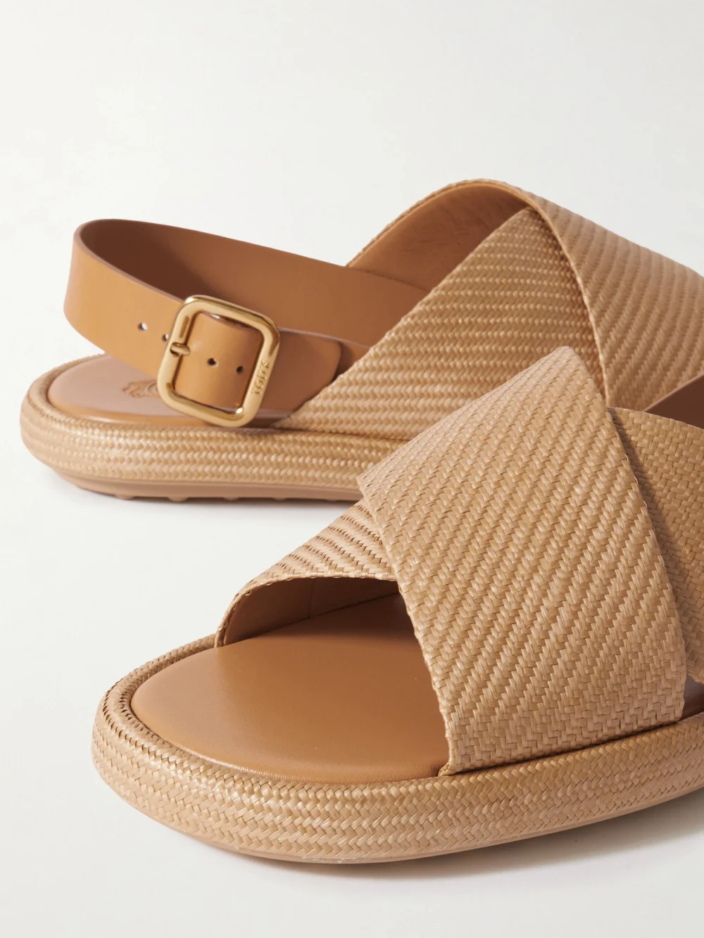 Close-up detail of the Tod's Gomma Leather-trimmed Raffia Slingback Sandals