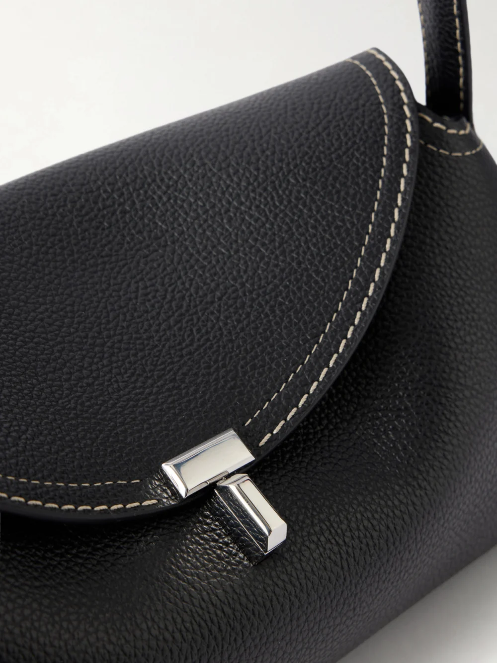 Close-up detail of the Totême T-lock Full-grain Leather Shoulder Bag