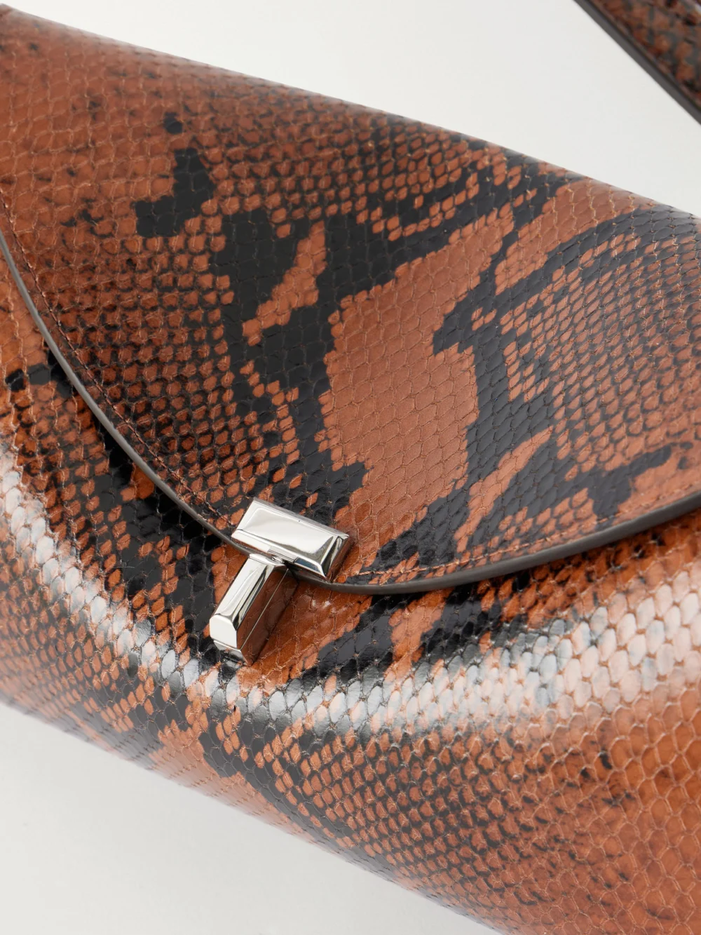 Close-up detail of the Totême T-lock Snake-effect Leather Shoulder Bag