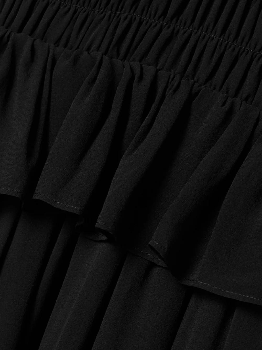 Close-up detail of the Ulla Johnson Adeline Shirred Silk Crepe De Chine Peplum Midi Dress