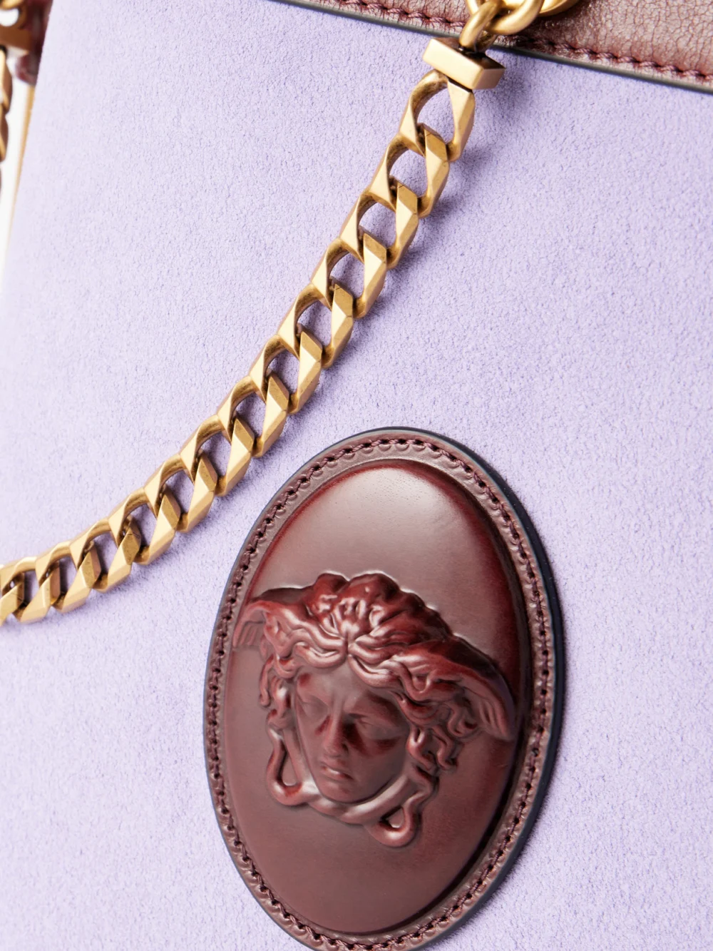 Close-up detail of the Versace Pivot Leather-trimmed Suede Bucket Bag