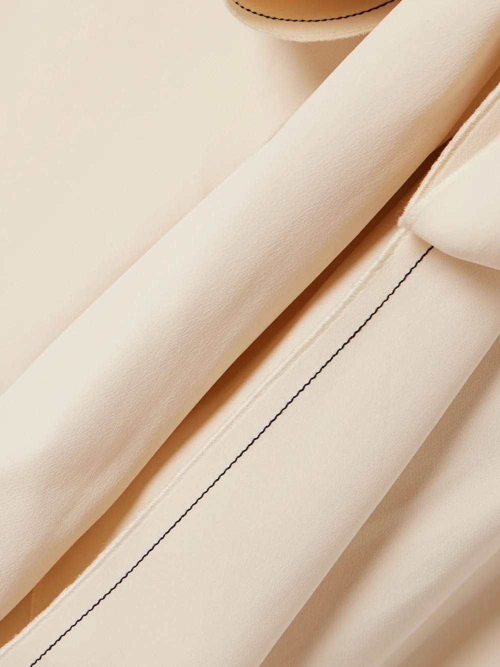 Close-up detail of the Victoria Beckham Asymmetric Tie-detailed Cady Midi Dress