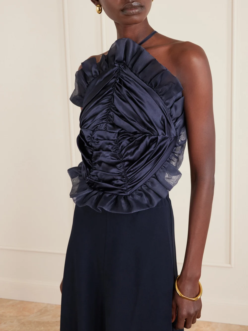 Close-up detail of the Violante Nessi Open-back Ruched Ruffled Organza-trimmed Silk-satin Halterneck Gown