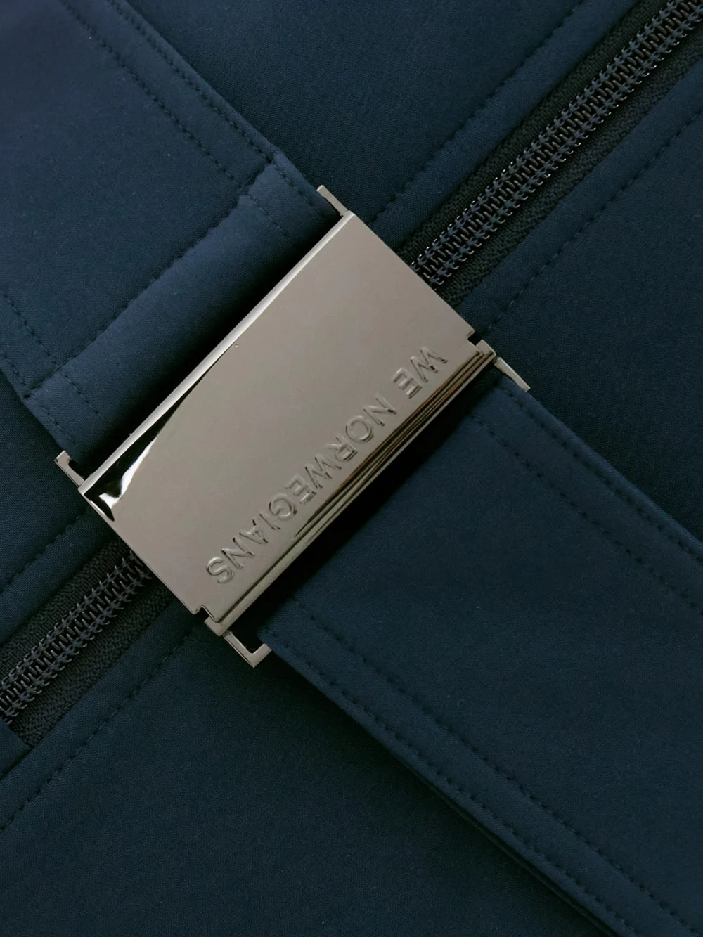 Close-up detail of the We Norwegians Tyn Belted Stretch-jersey Jumpsuit