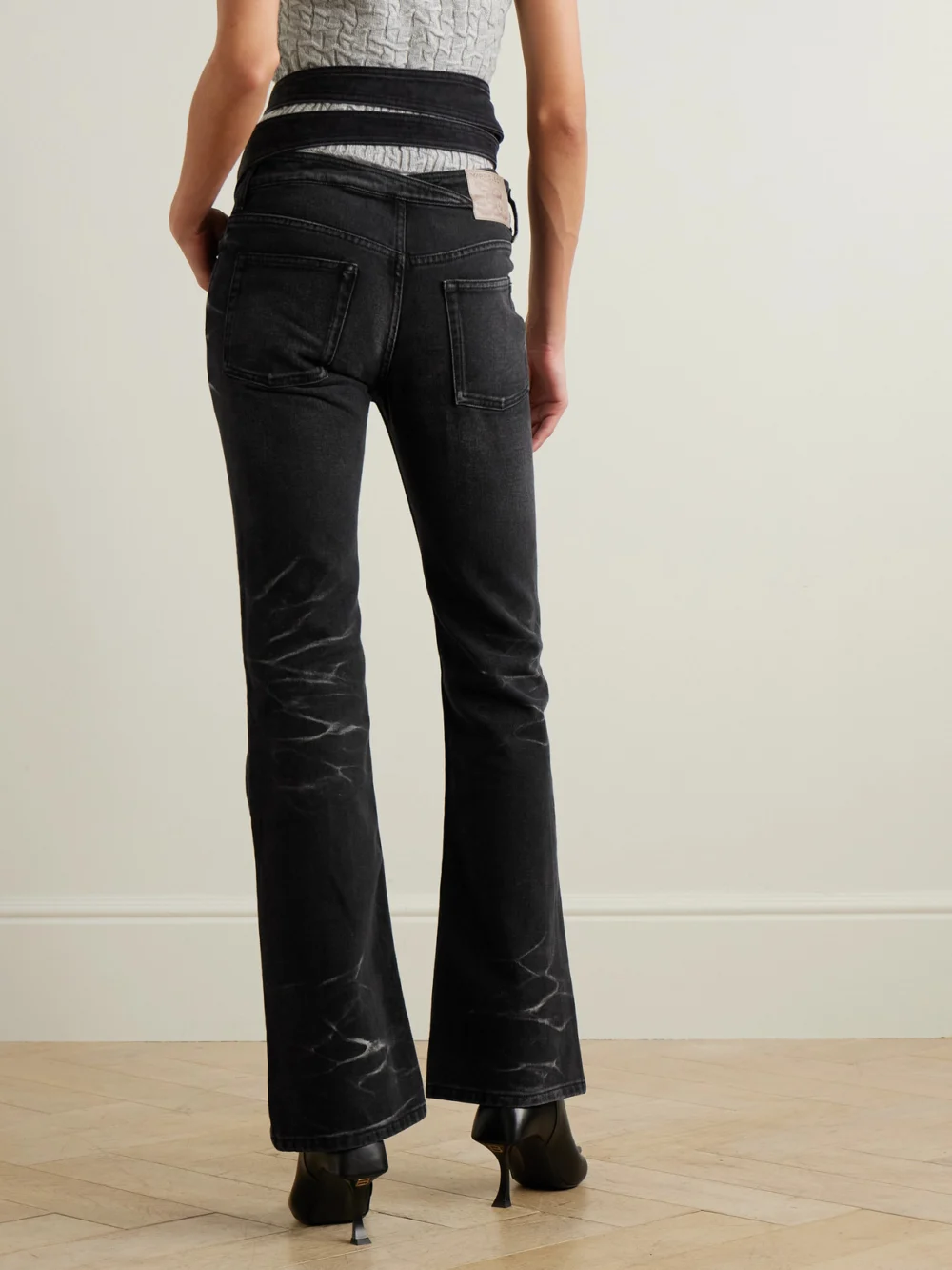 Back view of the Y/Project Belted Bleached Low-rise Flared Jeans