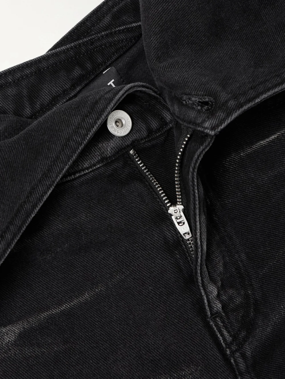 Close-up detail of the Y/Project Belted Bleached Low-rise Flared Jeans