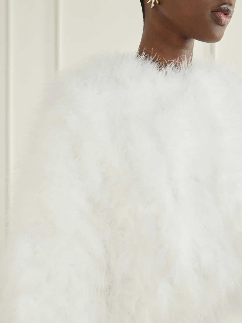 Close-up detail of the Yves Salomon Cropped Feather-trimmed Satin Cape