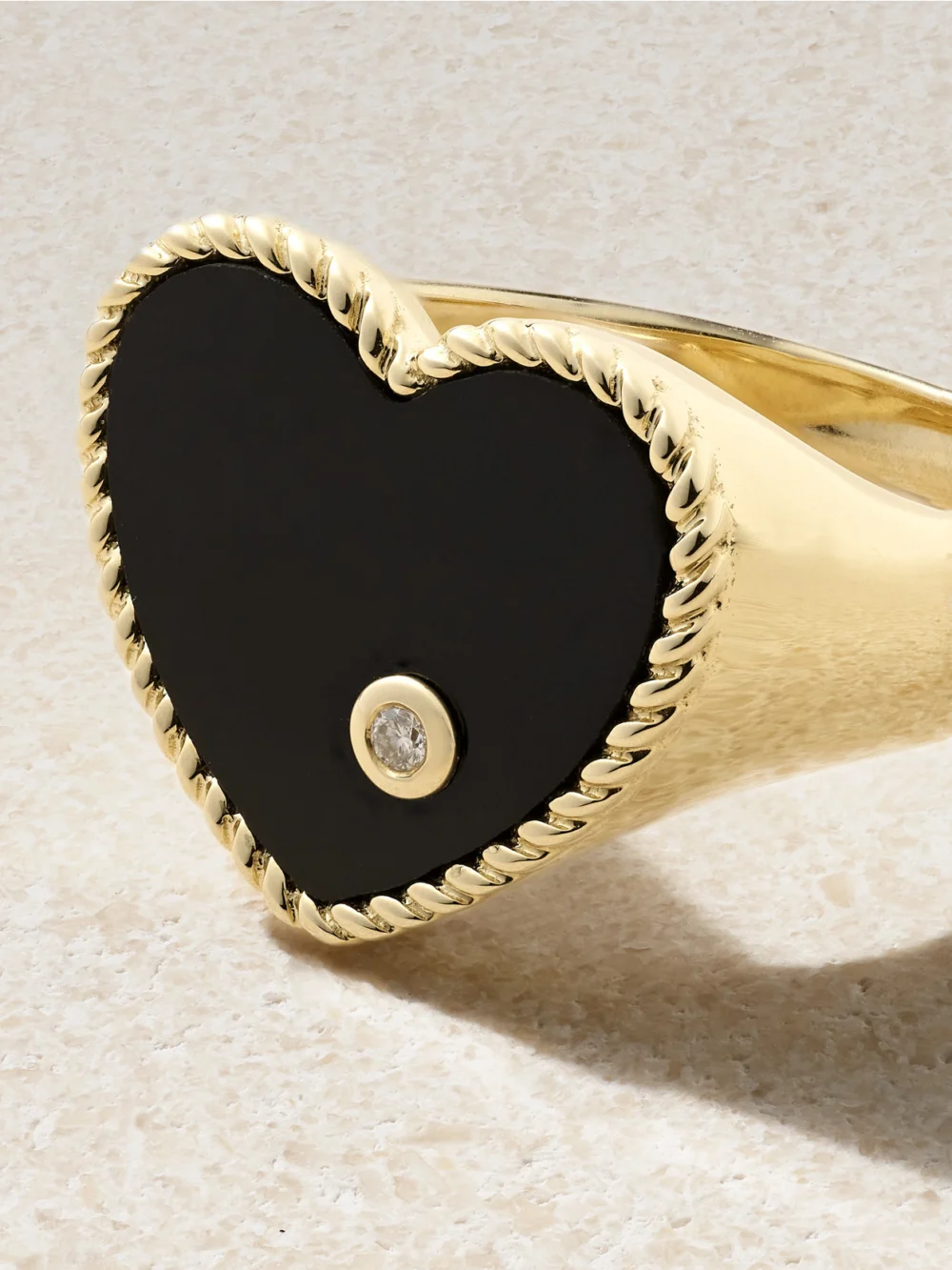 Close-up detail of the Yvonne Léon Chevalière Coeur 9-karat Gold, Onyx and Diamond Ring