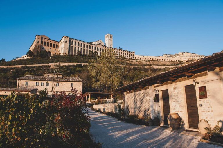 A lane between the borgo's stone houses, looking up to the Basilica of San Francesco, Borgo Antichi Orti Assisi