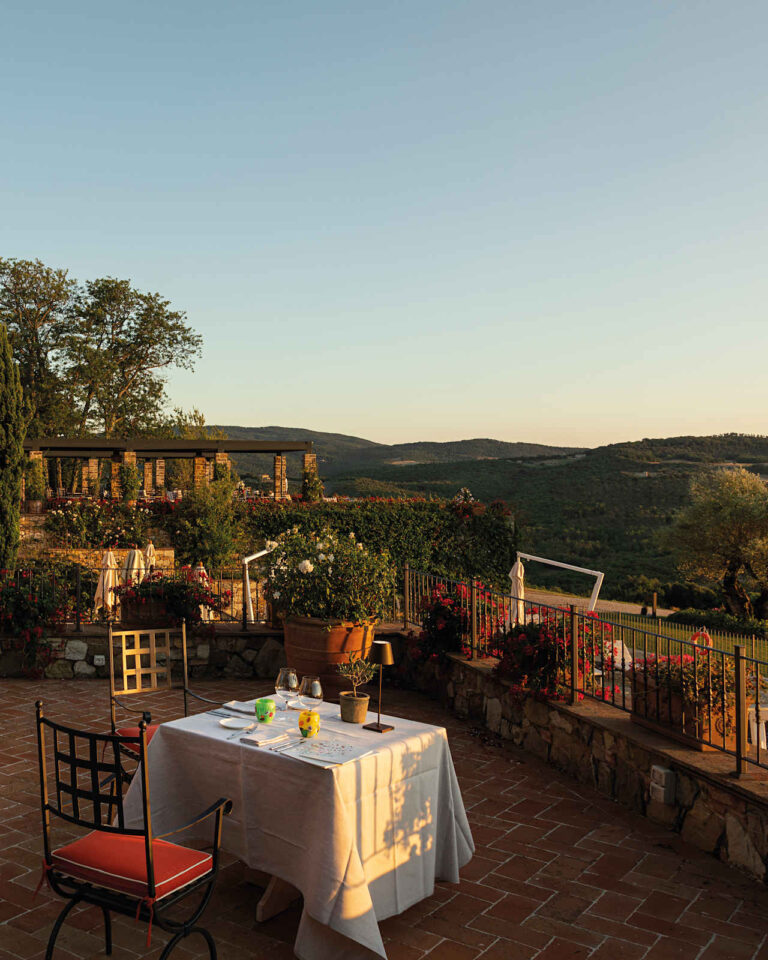 Visconti terrace table for two at sunset overlooking the hills, Castello di Casole
