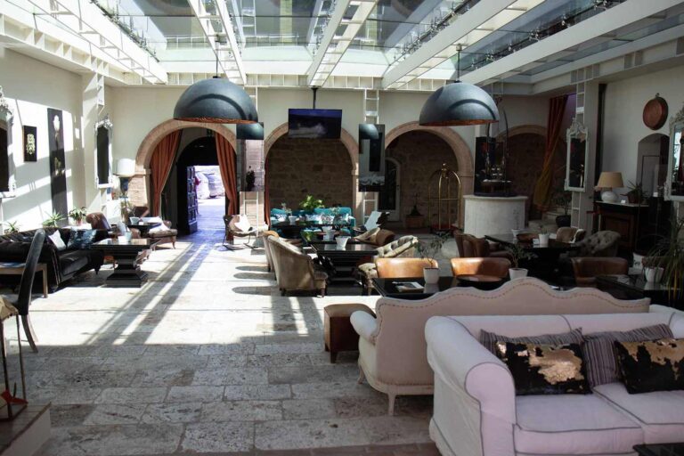 The lobby lounge under its glass roof, with stone arches, Castello di Velona Resort