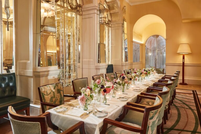 The Foyer private dining room with a long table dressed with flowers, Claridge's