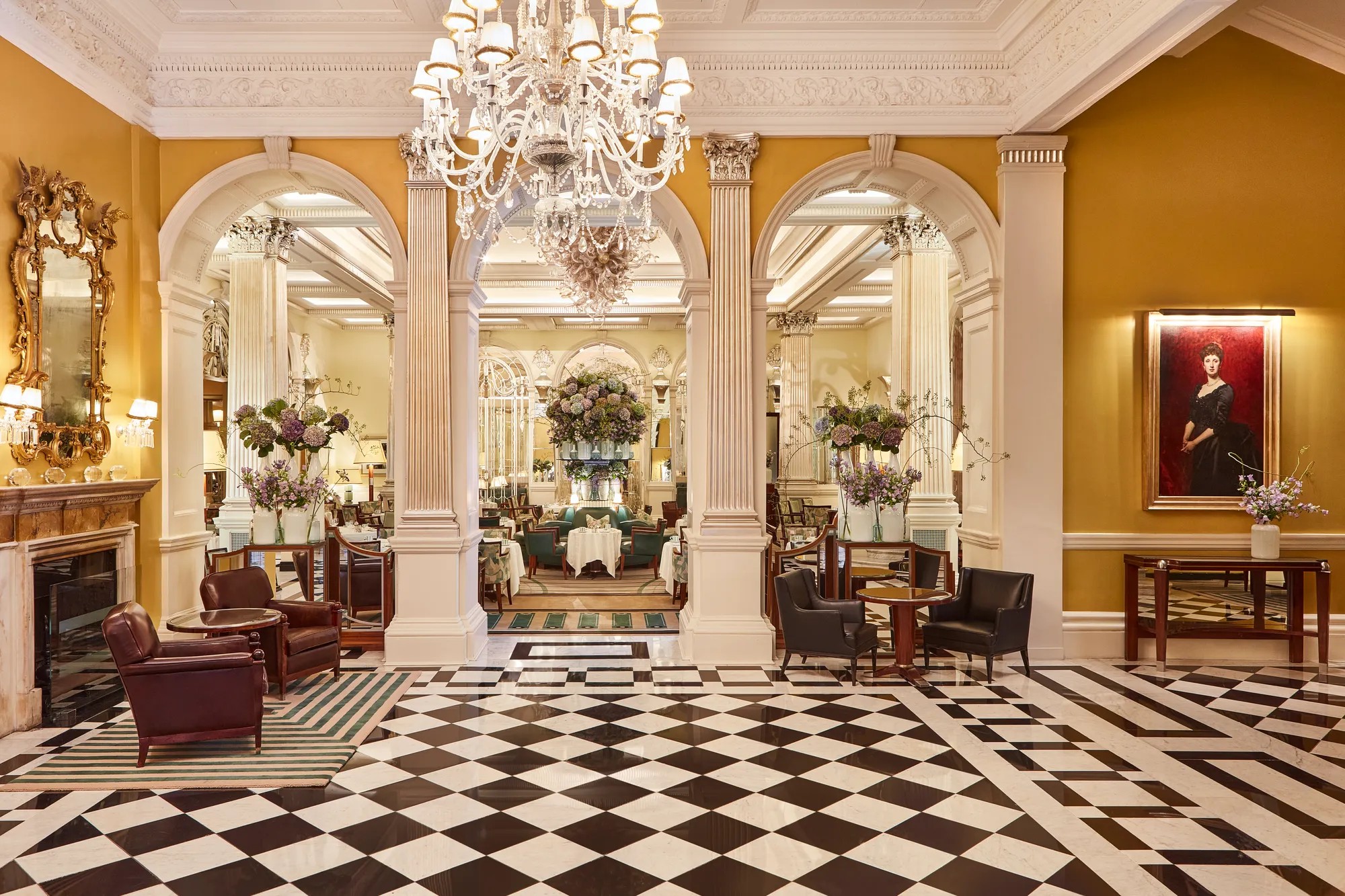 The lobby with its black and white chequered marble floor, gilded columns and chandelier, Claridge's