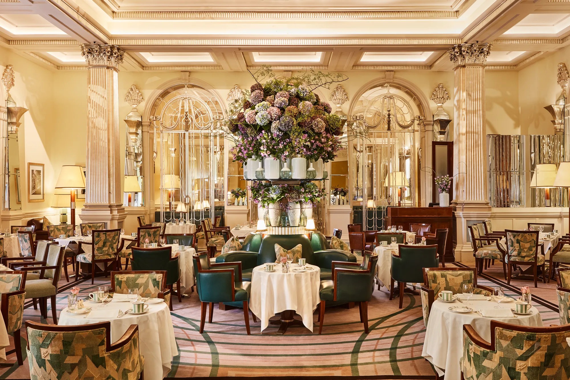 The Foyer and Reading Room set for service under a glass chandelier and mirrored walls, Claridge's