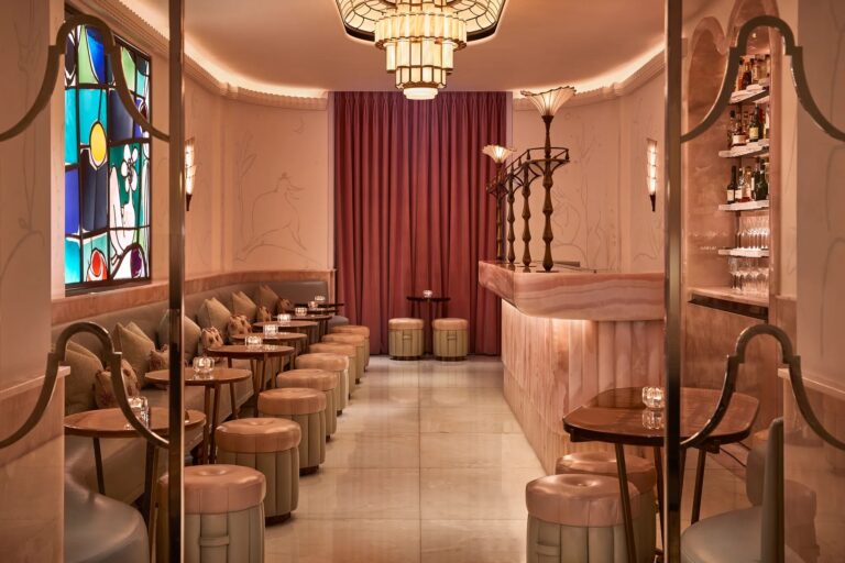 The Painter's Room with pink tones, stained glass panels and a line of bar stools, Claridge's