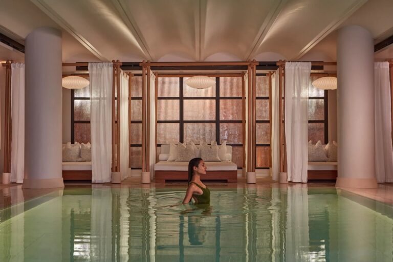 The spa pool framed by stone columns and a vaulted ceiling, Claridge's