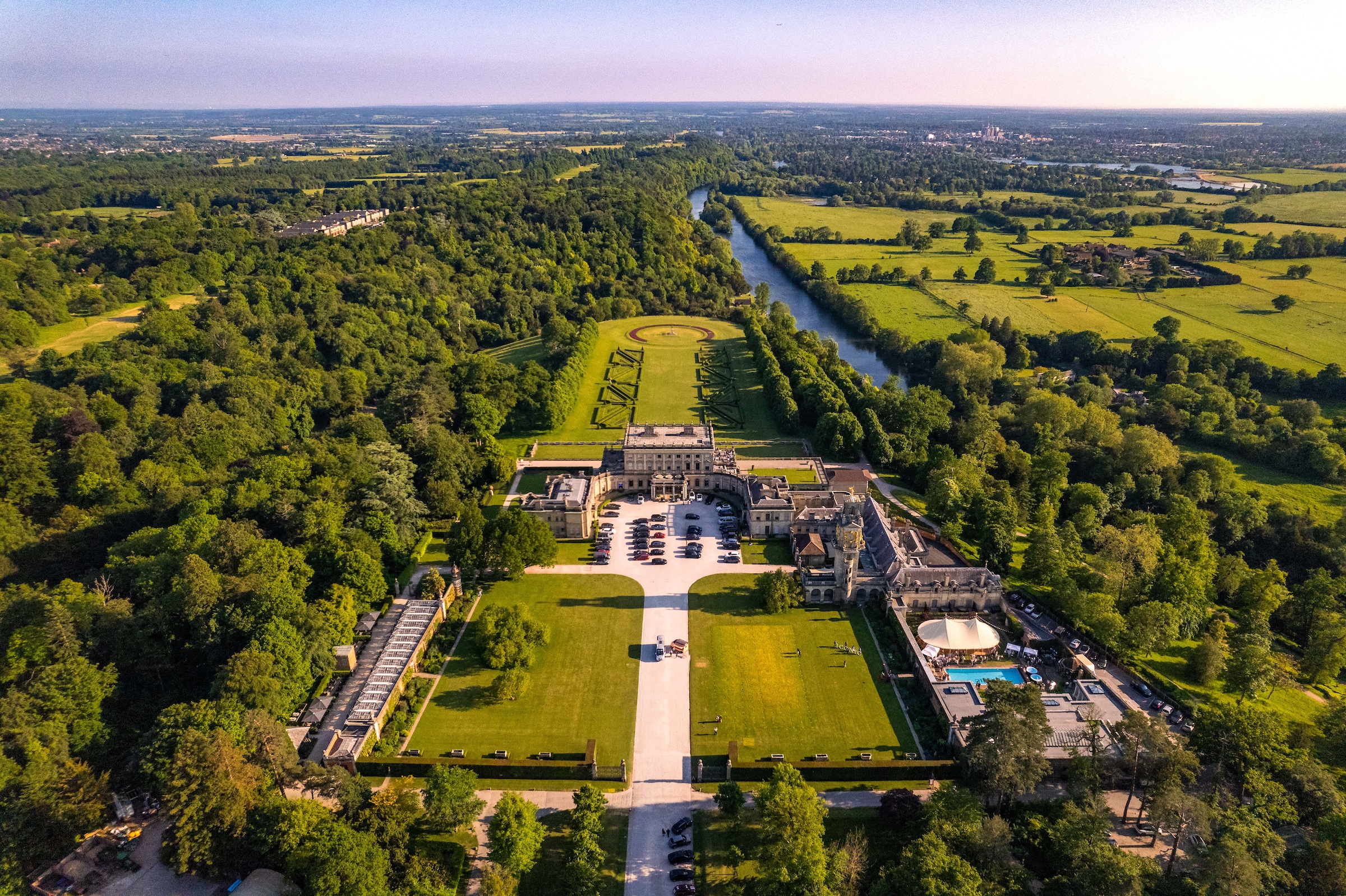 Aerial view of the house, its gardens and the woodland running down to the River Thames, Cliveden House