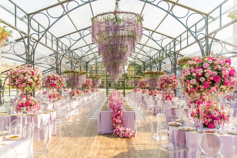 A glass marquee with a wisteria chandelier, lilac tables and pink rose arrangements, Cliveden House