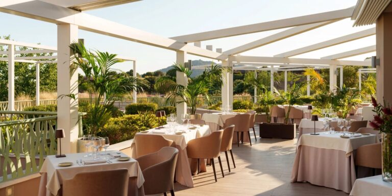 The outdoor terrace of La Terrazza, the Conrad's main restaurant, under a pergola, Conrad Chia Laguna Sardinia