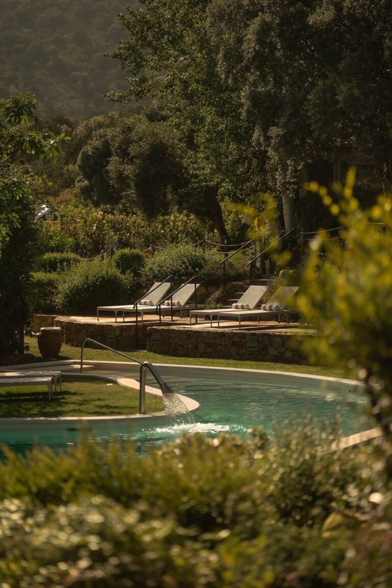 The Oasi pool among trees and planting on the upper hillside, Conrad Chia Laguna Sardinia