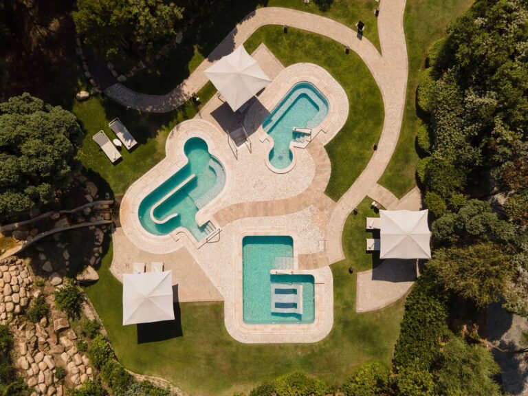 The Bioaquam pools of the Conrad Spa from above, set in lawns and Mediterranean planting, Conrad Chia Laguna Sardinia