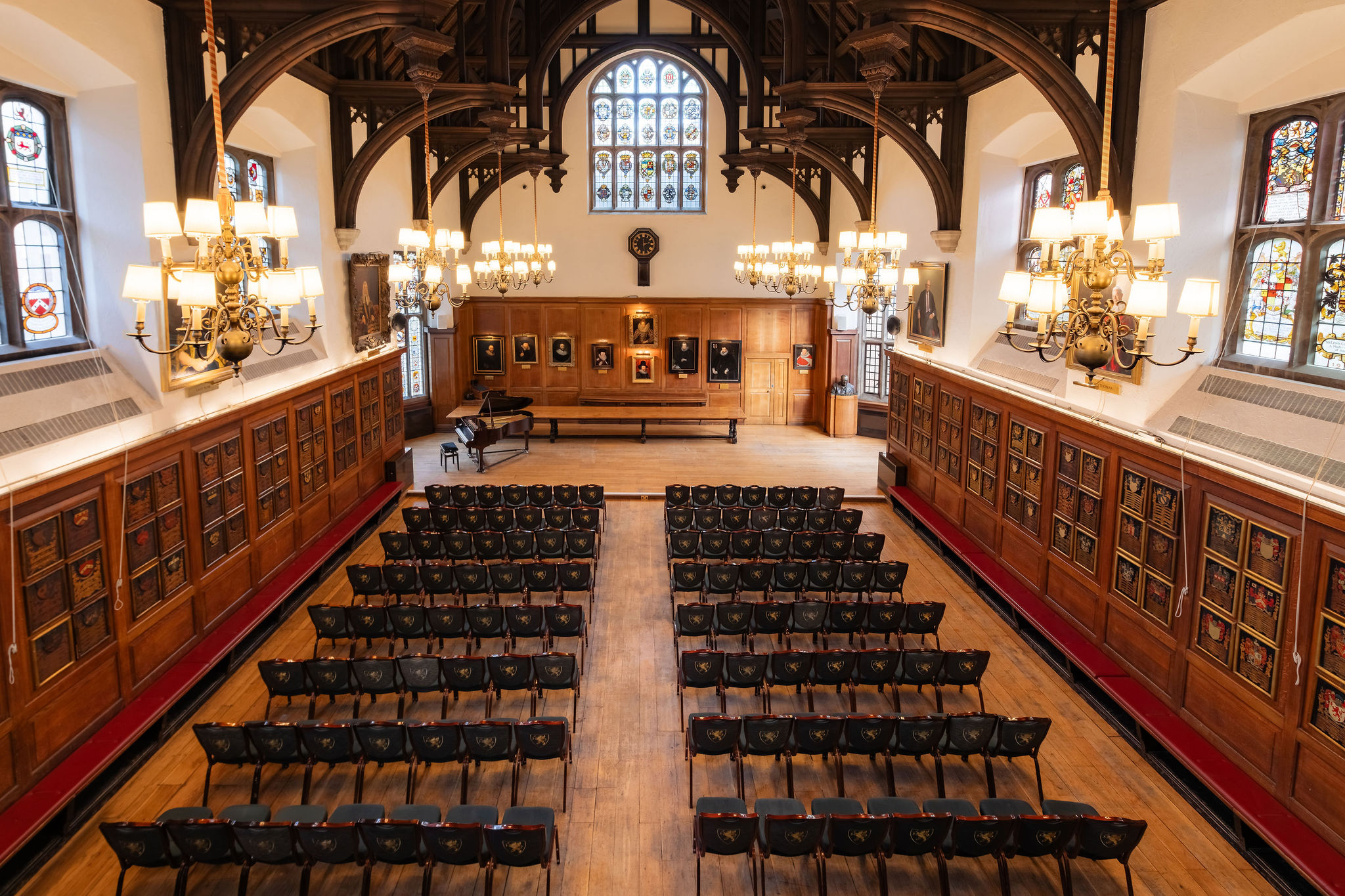 Rows of chairs set out down the Hall between the panelled walls, facing the far end, Gray's Inn