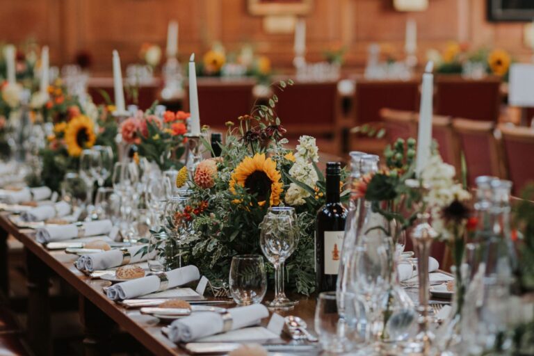 A long table dressed with sunflowers, dahlias and candles for a summer wedding, Gray's Inn