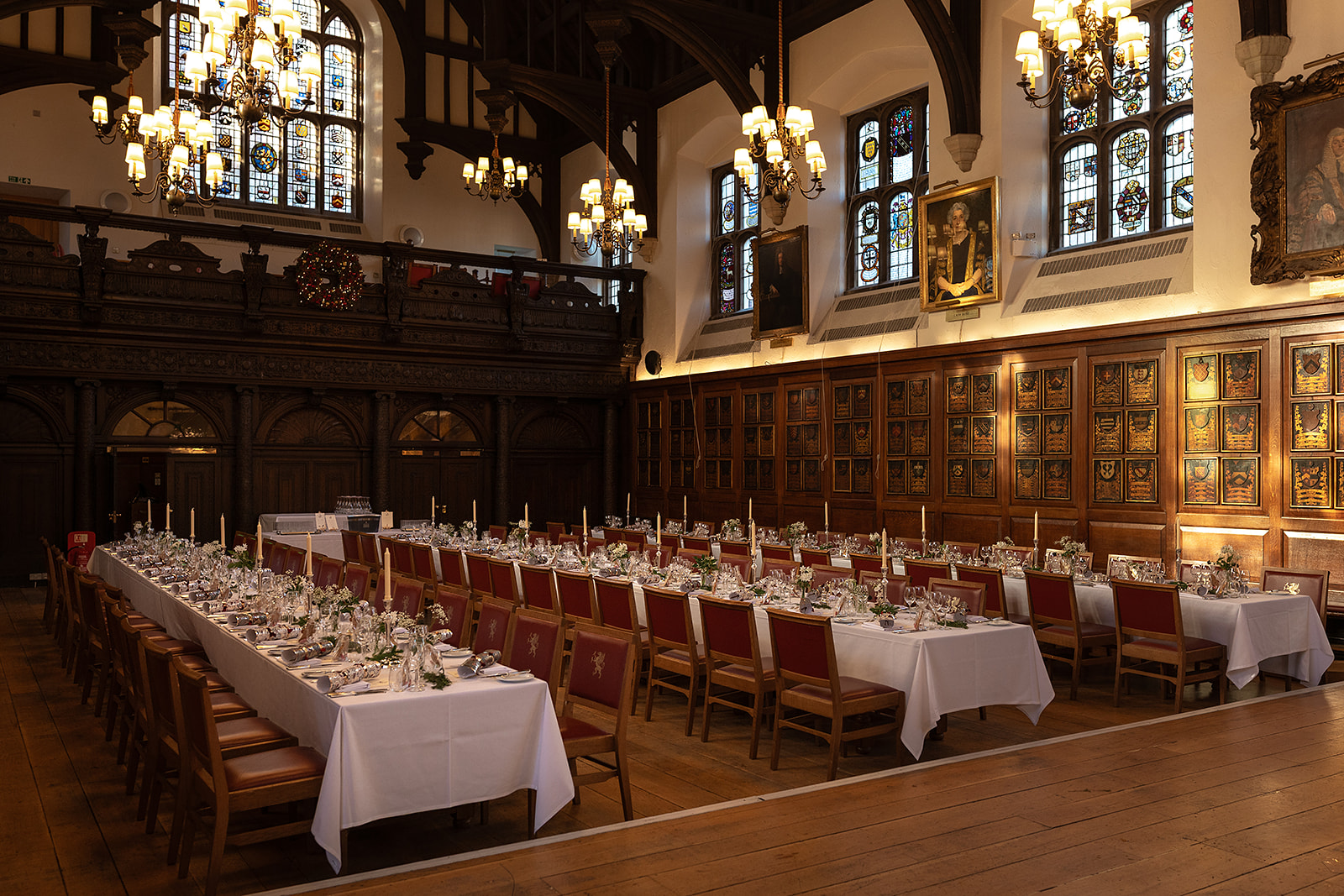 Long dressed tables in the Hall, with the carved wooden screen and gallery at the end, Gray's Inn