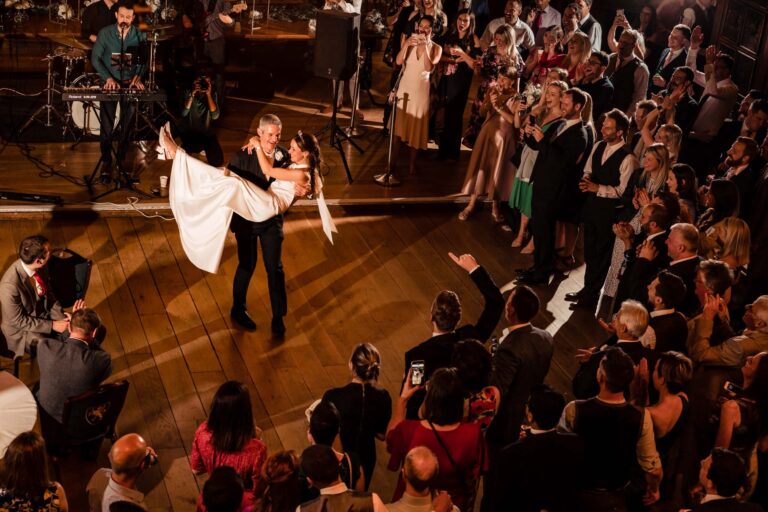A couple dancing on the wooden floor of the Hall, ringed by their guests, Gray's Inn