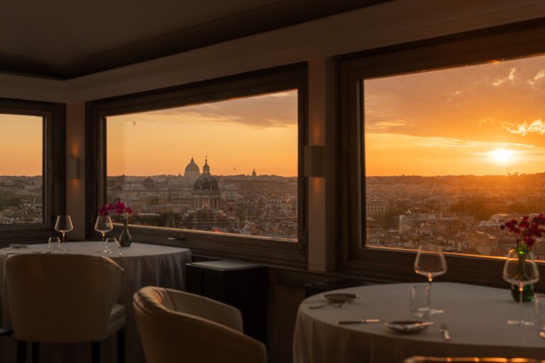 Imàgo restaurant at sunset, tables by the panoramic windows over Rome, Hassler Roma