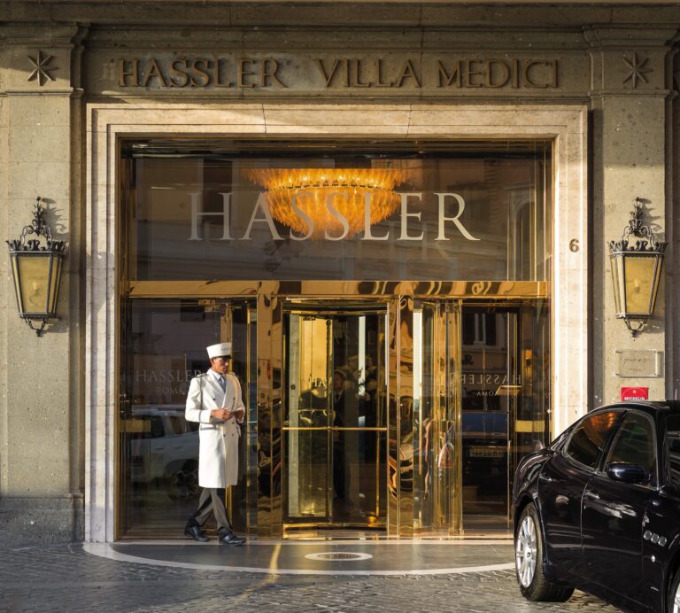 The Hassler Villa Medici entrance on Piazza Trinità dei Monti, with a doorman at the revolving door, Hassler Roma