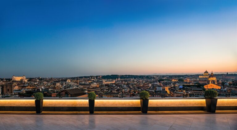 The Villa Medici Penthouse terrace at dusk, with Rome laid out below, Hassler Roma