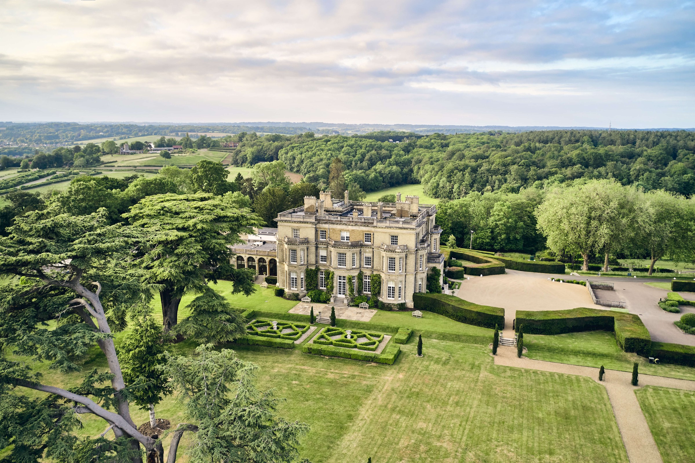 The house from the air with its parterre, lawns and cedar trees, and the wooded Thames Valley beyond, Hedsor House