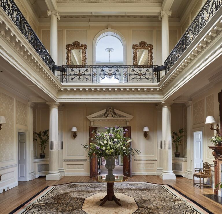 Centre Hall, with its columns, first-floor balcony and domed ceiling, set with a single flower urn, Hedsor House