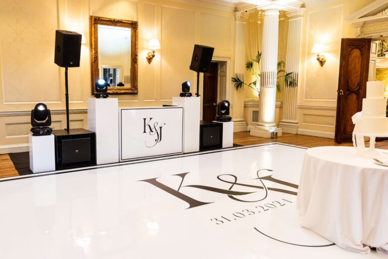 A white dance floor with the couple's monogram and a DJ booth set up for the evening, Hedsor House