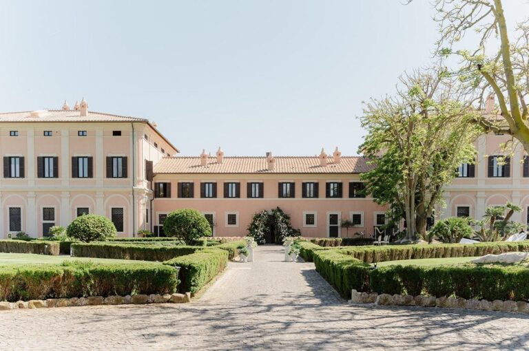 The formal garden walk leading to the villa facade, La Posta Vecchia Hotel