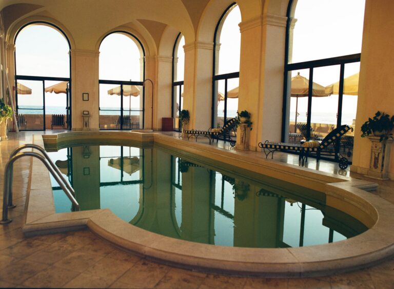 The marble-lined indoor pool with arched windows onto the sea, La Posta Vecchia Hotel