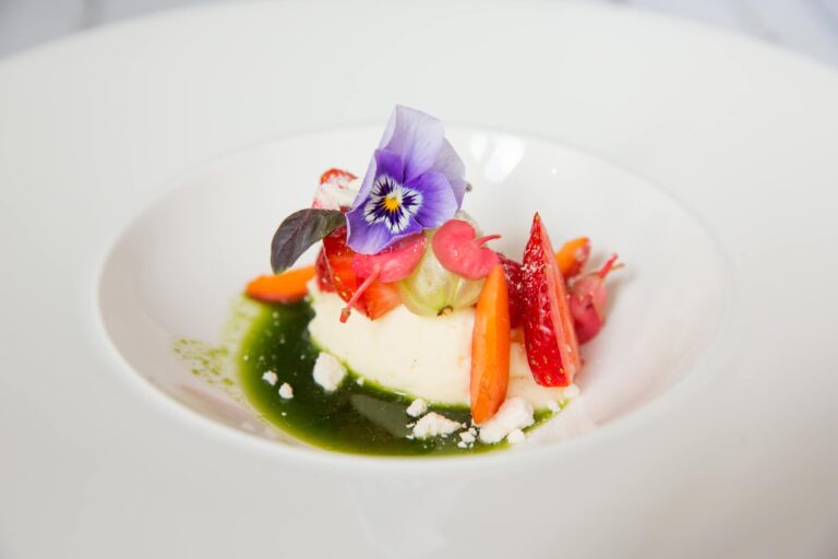 A plated dessert with strawberries, edible pansy and a green herb sauce, Leeds Castle