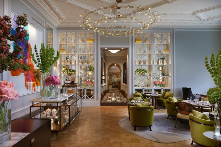 The Rosebery, with green armchairs, a floral display and glass-fronted cabinets, Mandarin Oriental Hyde Park