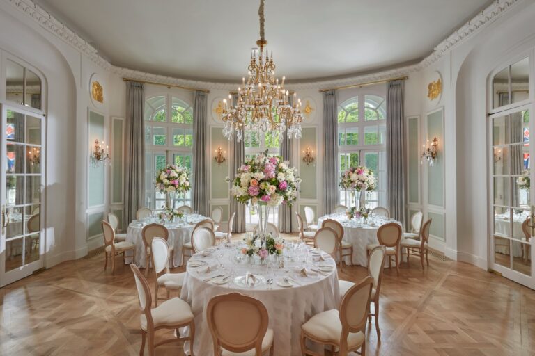The Loggia set with round tables, flowers and a crystal chandelier, French windows on every side, Mandarin Oriental Hyde Park